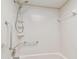 Bathroom with a tub, shower, grab bars, and neutral-toned walls at 11200 102Nd Ave # 33, Seminole, FL 33778