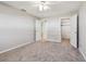 Bright bedroom with neutral walls, ceiling fan, and carpeting; access to closets and bathroom at 11200 102Nd Ave # 33, Seminole, FL 33778