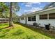 White building exterior with green lawn and mature trees at 11200 102Nd Ave # 33, Seminole, FL 33778
