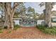 Twin Oaks entrance gate with lush landscaping and mature trees at 11200 102Nd Ave # 33, Seminole, FL 33778