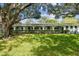 Exterior of a light blue building with a large tree and manicured lawn at 11200 102Nd Ave # 33, Seminole, FL 33778