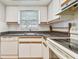 White kitchen with wood cabinets and dark countertops at 11200 102Nd Ave # 33, Seminole, FL 33778
