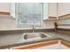 Kitchen with stainless steel sink, wood countertops, and white cabinets at 11200 102Nd Ave # 33, Seminole, FL 33778