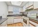 White kitchen with wood cabinets and dark countertops at 11200 102Nd Ave # 33, Seminole, FL 33778