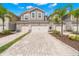 Charming townhomes offer a neutral exterior, lush landscaping, and a brick-paved two-car driveway at 5018 Sunnyside Ln, Bradenton, FL 34211