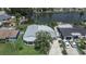 Aerial view of a well-maintained home with a lush lawn and access to a tranquil canal at 4041 Star Island Dr, Holiday, FL 34691