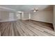 Spacious living room featuring wood-look floors and neutral paint, bathed in natural light at 6969 Oldgate Cir, New Port Richey, FL 34655