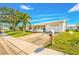 White single-story home with a two-car garage and palm trees at 9125 39Th N Ln, Pinellas Park, FL 33782