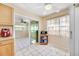 Kitchen with light wood cabinets, appliances, and view to sunroom at 9125 39Th N Ln, Pinellas Park, FL 33782
