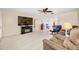 Spacious living room with tile floors, comfy furniture, and a ceiling fan at 9125 39Th N Ln, Pinellas Park, FL 33782