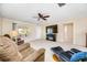 Living room with tile floors, a large TV, and a fireplace at 9125 39Th N Ln, Pinellas Park, FL 33782