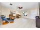 Living room with tile floors, two brown recliners, and a ceiling fan at 9125 39Th N Ln, Pinellas Park, FL 33782