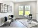 Home office with two armchairs and a desk, providing a workspace with natural light at 22426 Golden Retriever Ln, Brooksville, FL 34601