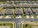 Aerial view of a community with numerous houses and lush green landscaping at 31932 Stillmeadow Dr, Wesley Chapel, FL 33543