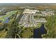 Aerial view showing a large community of houses near a lake and conservation at 31932 Stillmeadow Dr, Wesley Chapel, FL 33543