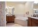 Bathroom features a large garden tub, double sinks, and ample storage at 31932 Stillmeadow Dr, Wesley Chapel, FL 33543