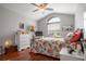 Bedroom with hardwood floors, ceiling fan and large window at 31932 Stillmeadow Dr, Wesley Chapel, FL 33543