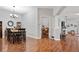 Bright dining room with hardwood floors and view into Gathering room at 31932 Stillmeadow Dr, Wesley Chapel, FL 33543