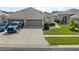 Two-car garage and well-manicured lawn at 31932 Stillmeadow Dr, Wesley Chapel, FL 33543