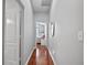 Hallway with hardwood floors and access to bedroom at 31932 Stillmeadow Dr, Wesley Chapel, FL 33543