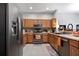 Well-equipped kitchen with wood cabinets, stainless steel appliances, and tile flooring at 31932 Stillmeadow Dr, Wesley Chapel, FL 33543