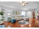 Spacious living room with hardwood floors, a comfortable sectional sofa, and lots of natural light at 31932 Stillmeadow Dr, Wesley Chapel, FL 33543