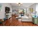 Bright and spacious living room with hardwood floors and access to a backyard patio at 31932 Stillmeadow Dr, Wesley Chapel, FL 33543