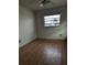 Empty bedroom with wood floors and natural light from the window at 480 82Nd Ave, St Pete Beach, FL 33706