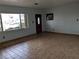 Bright living room boasting tiled floors, a decorative front door, and a large window at 480 82Nd Ave, St Pete Beach, FL 33706