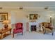 Living area with fireplace and armchairs at 8 Belleview Blvd # 408, Belleair, FL 33756