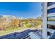 Lovely view of a pond, landscaping, and other buildings from a balcony at 8 Belleview Blvd # 408, Belleair, FL 33756