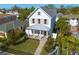 White two-story house with a gray roof, surrounded by lush landscaping at 245 12Th Ne Ave, St Petersburg, FL 33701