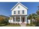 Two-story farmhouse with white siding, shutters, and a metal roof at 245 12Th Ne Ave, St Petersburg, FL 33701