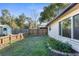 View of the backyard, featuring a storage shed and a new fence at 5479 Pinehurst Dr, Spring Hill, FL 34606