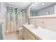 Bright bathroom featuring a vanity with large mirror and a shower/tub combo with decorative curtain at 5479 Pinehurst Dr, Spring Hill, FL 34606
