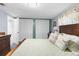 Bedroom with closet, serene color palette, and well-coordinated furnishings for a comfortable retreat at 5479 Pinehurst Dr, Spring Hill, FL 34606