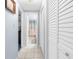 Bright hallway with tiled floor, closet, and easy access to adjacent rooms and bathroom at 5479 Pinehurst Dr, Spring Hill, FL 34606