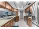 Well-equipped kitchen with wood cabinets, stainless steel appliances, and stylish countertops at 5479 Pinehurst Dr, Spring Hill, FL 34606