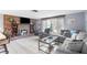 Inviting living room with a brick fireplace, a comfortable sofa, and a large window at 5479 Pinehurst Dr, Spring Hill, FL 34606