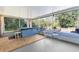Enclosed sunroom features a hot tub, a concrete pad, and a view of the fenced in yard at 5479 Pinehurst Dr, Spring Hill, FL 34606