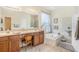 Bright bathroom features a dual sink vanity, soaking tub, and tiled shower at 10954 May Apple Ct, Land O Lakes, FL 34638