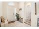 Welcoming entryway featuring neutral tones, tile flooring, and an arched transom window above the front door at 10954 May Apple Ct, Land O Lakes, FL 34638