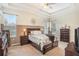 Serene main bedroom featuring a tray ceiling, plush carpeting, and an abundance of natural light at 10954 May Apple Ct, Land O Lakes, FL 34638