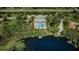 Aerial view of community with lakefront clubhouse and pool at 11833 Castine St, New Port Richey, FL 34654