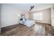 Bright bedroom with wood-look flooring and plantation shutters at 11833 Castine St, New Port Richey, FL 34654