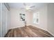 Bedroom with wood-look floors, ceiling fan, and double doors at 11833 Castine St, New Port Richey, FL 34654