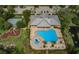 Aerial view of community pool, tennis courts, playground, and clubhouse at 11833 Castine St, New Port Richey, FL 34654