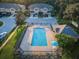 Aerial view of community pool with surrounding patio and lounge chairs at 11833 Castine St, New Port Richey, FL 34654