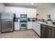 Modern kitchen with stainless steel appliances and white cabinets at 11833 Castine St, New Port Richey, FL 34654