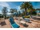 Relaxing pool deck area with lounge chairs and umbrellas at 11833 Castine St, New Port Richey, FL 34654